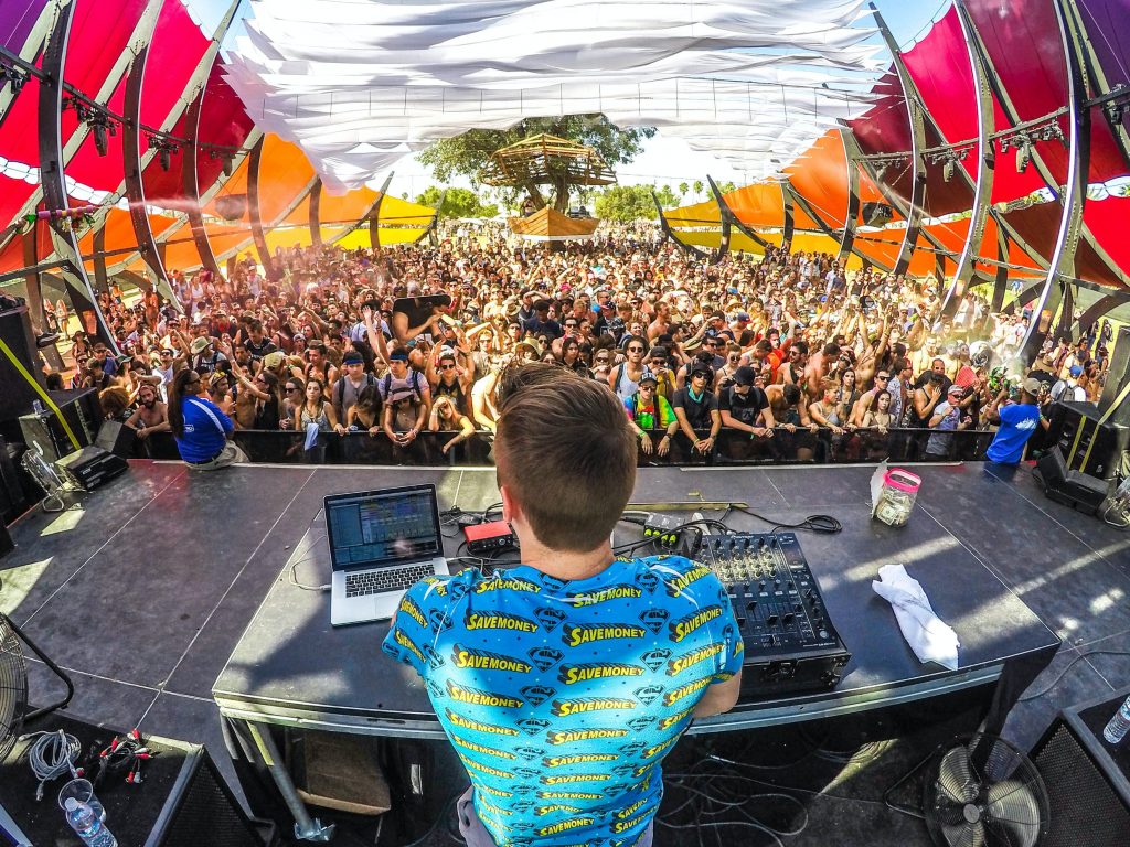 A DJ in front of a crowd at Coachella Music Festival. 