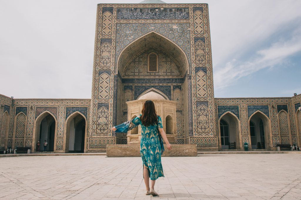A girl standing in front of a building in Khiva, on The Silk Road. 
