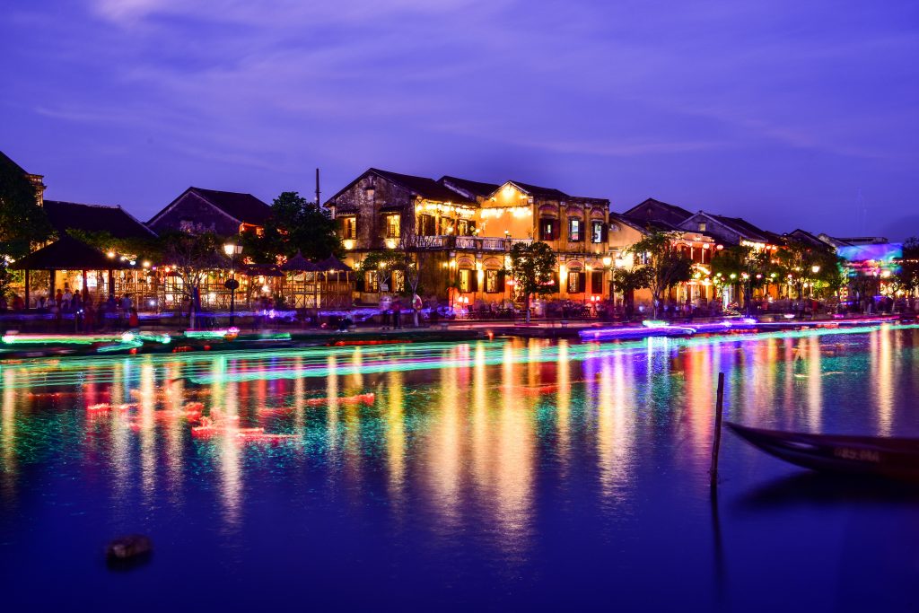 A colourful picture of the riverside in Hoi An lit up at night. 