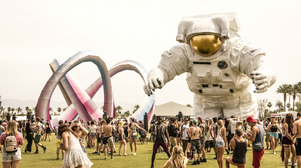 Coachella 2014, a giant astronaut floats above festival goers.  