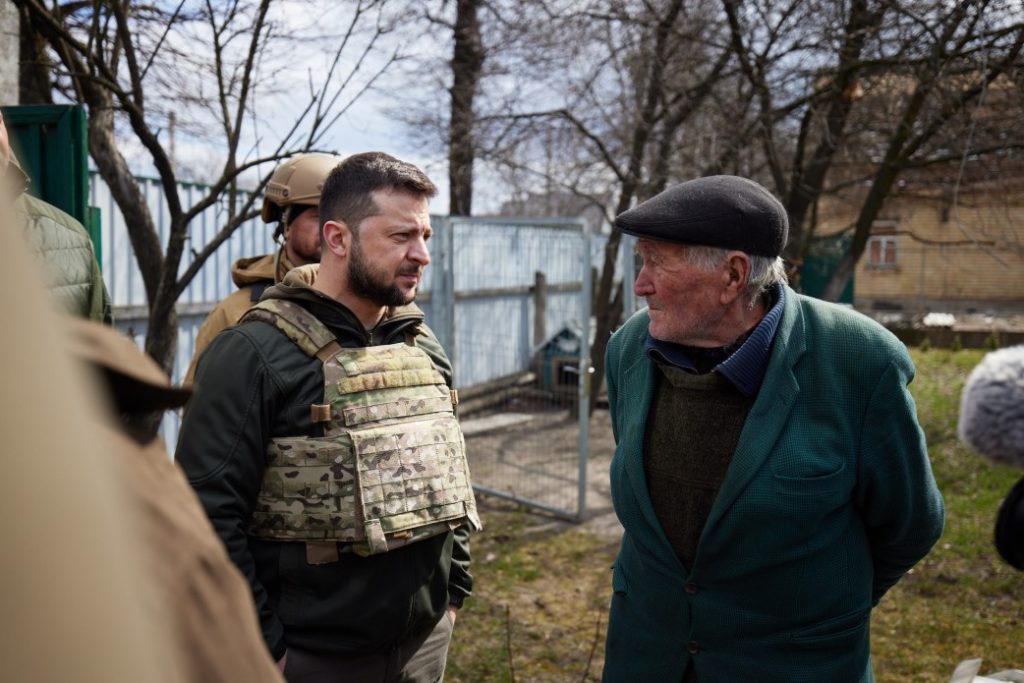 Vladimir Zelenskyy, who made a virtual address at the Grammys, speaks to a resident in Bucha. 