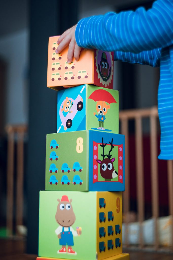 Old enough has toddlers crossing towns for groceries. Pictured: A stack of playing blocks. 