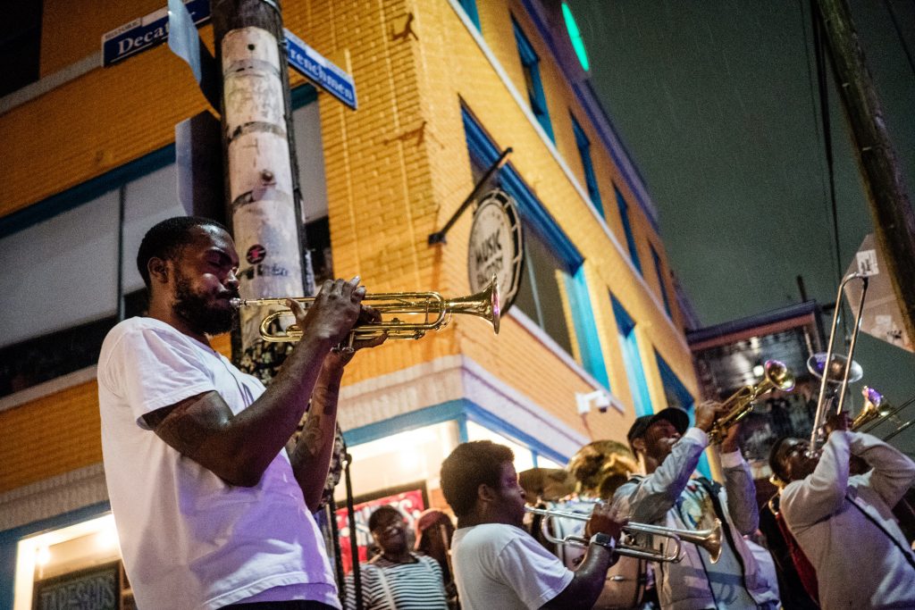 A man playing trumpet with a band in New Orleans.